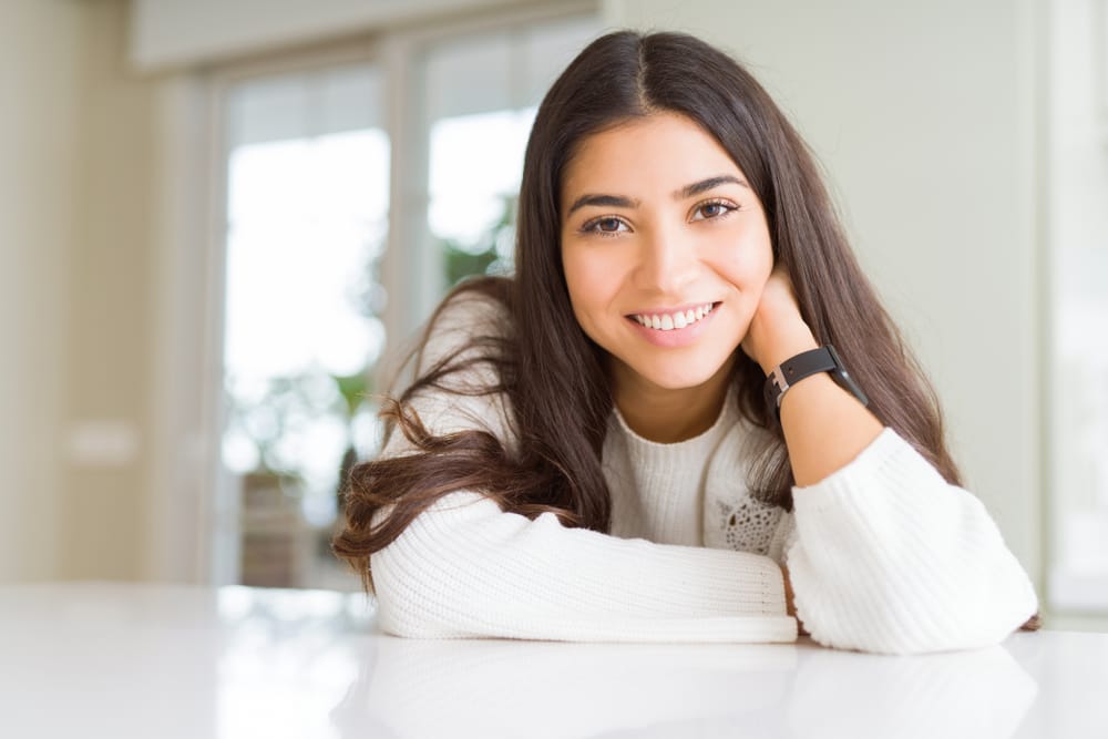 woman at home leaning on a table