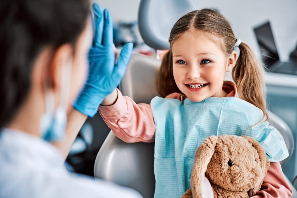 Little girl high fiving a dentist - Pediatric Dentist in Gahanna, Ohio