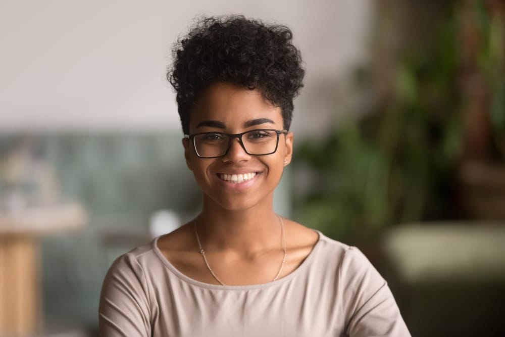 curly haired woman smiling - Black Dentist in Columbus, Ohio